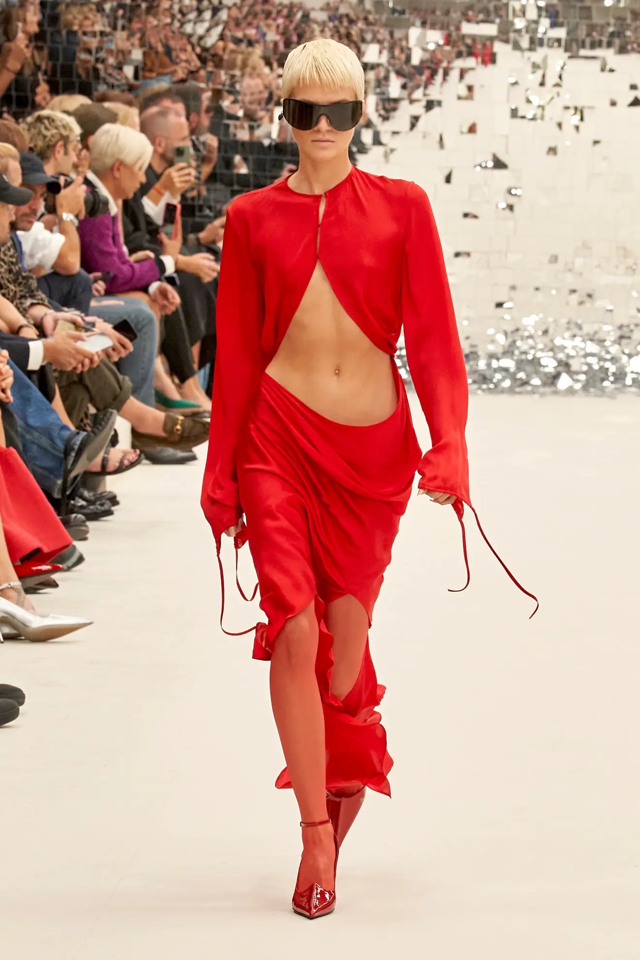 Model wears red dress on Acne SS24 runway