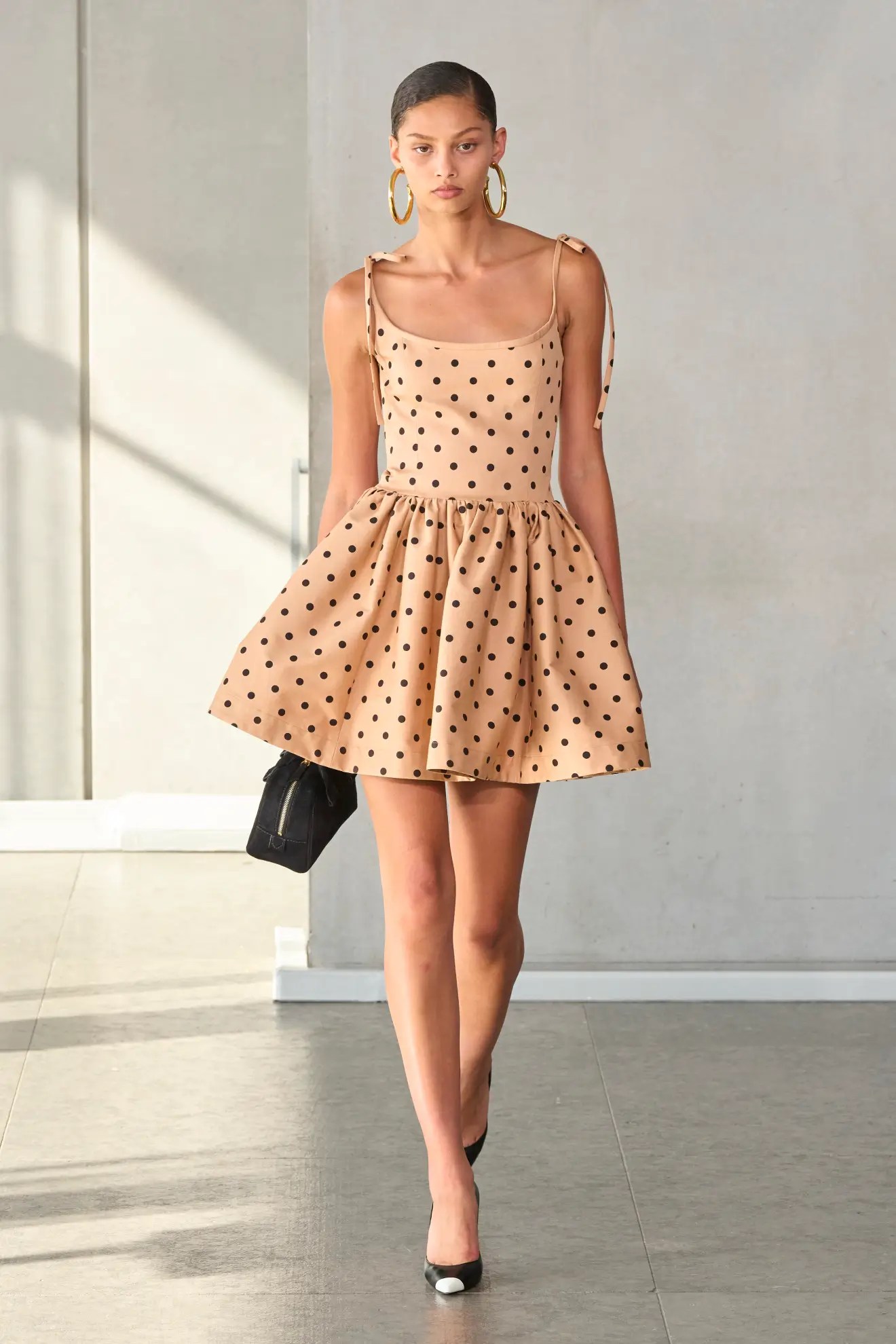 Model wears polka dot dress on the SS24 Carolina Herrera runway